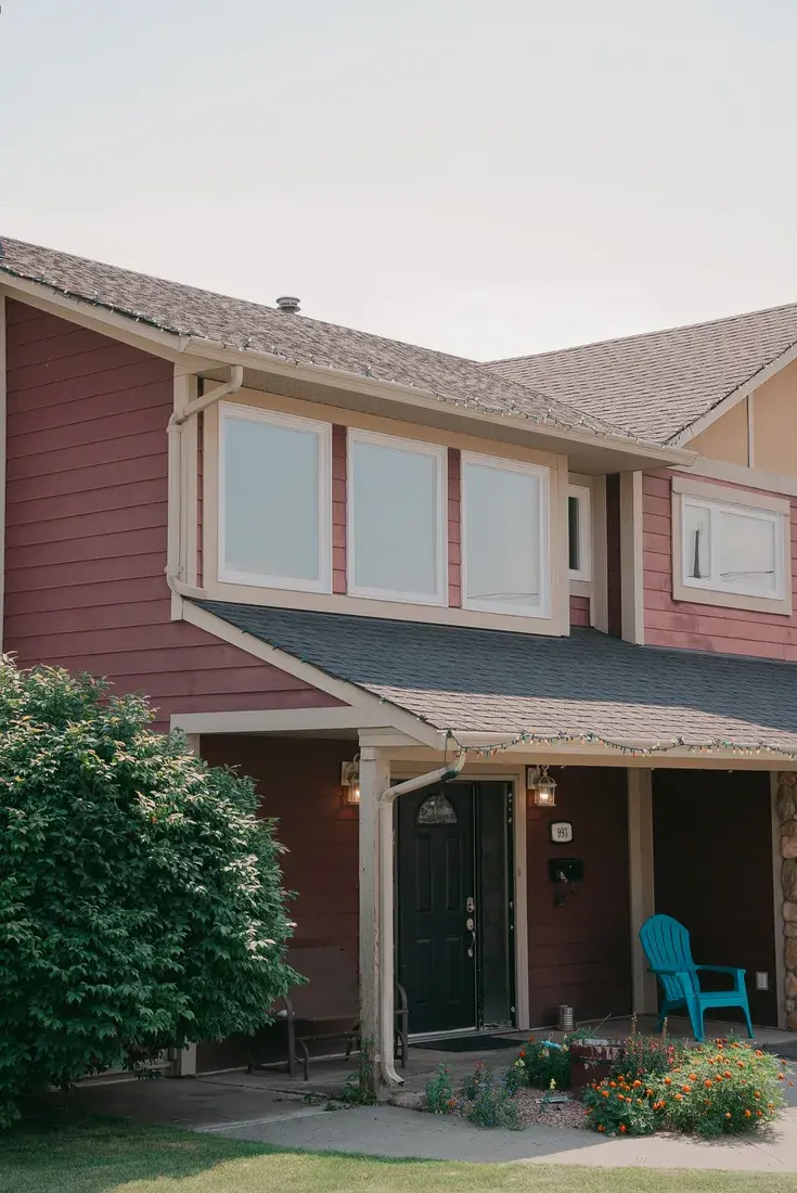 New windows installed on an Alberta home with red wood siding